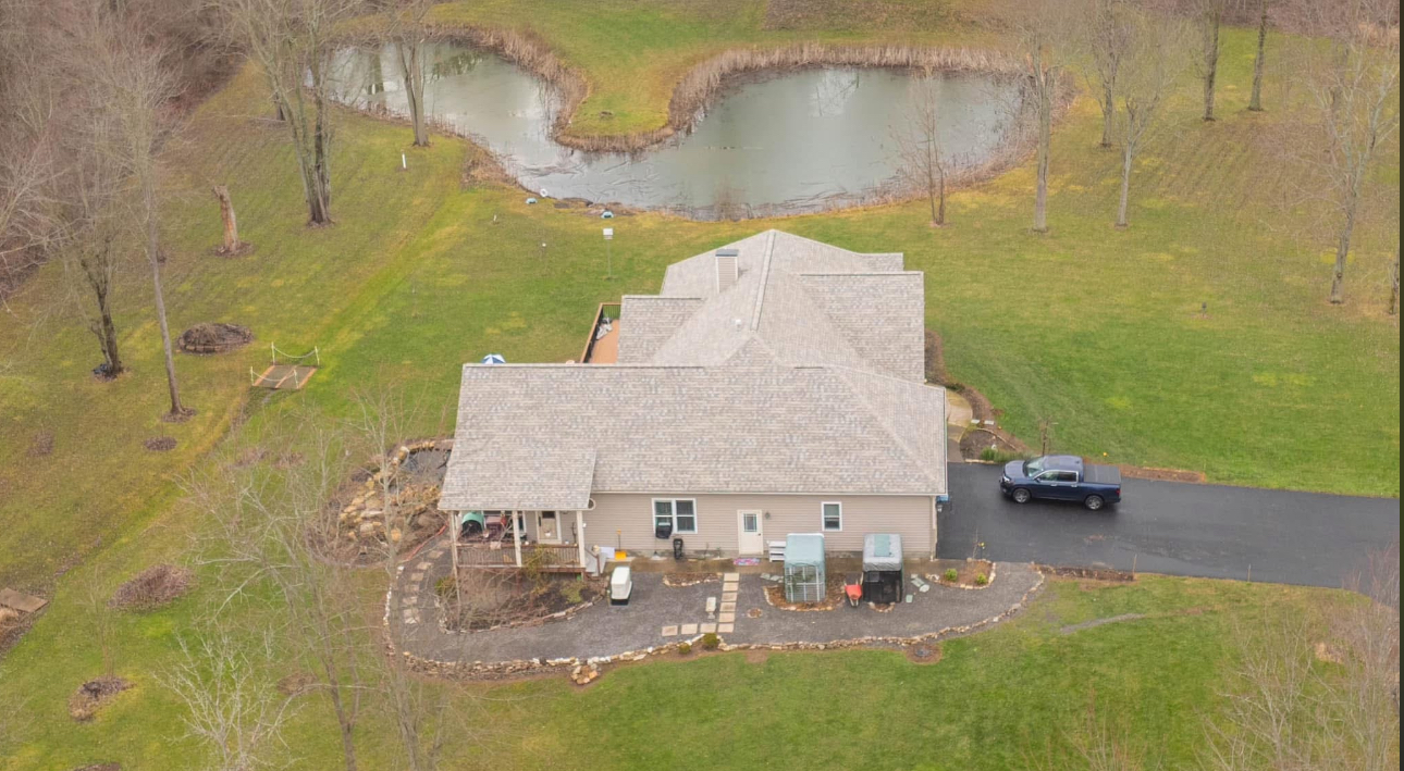 Completed residential roof - aerial view with pond