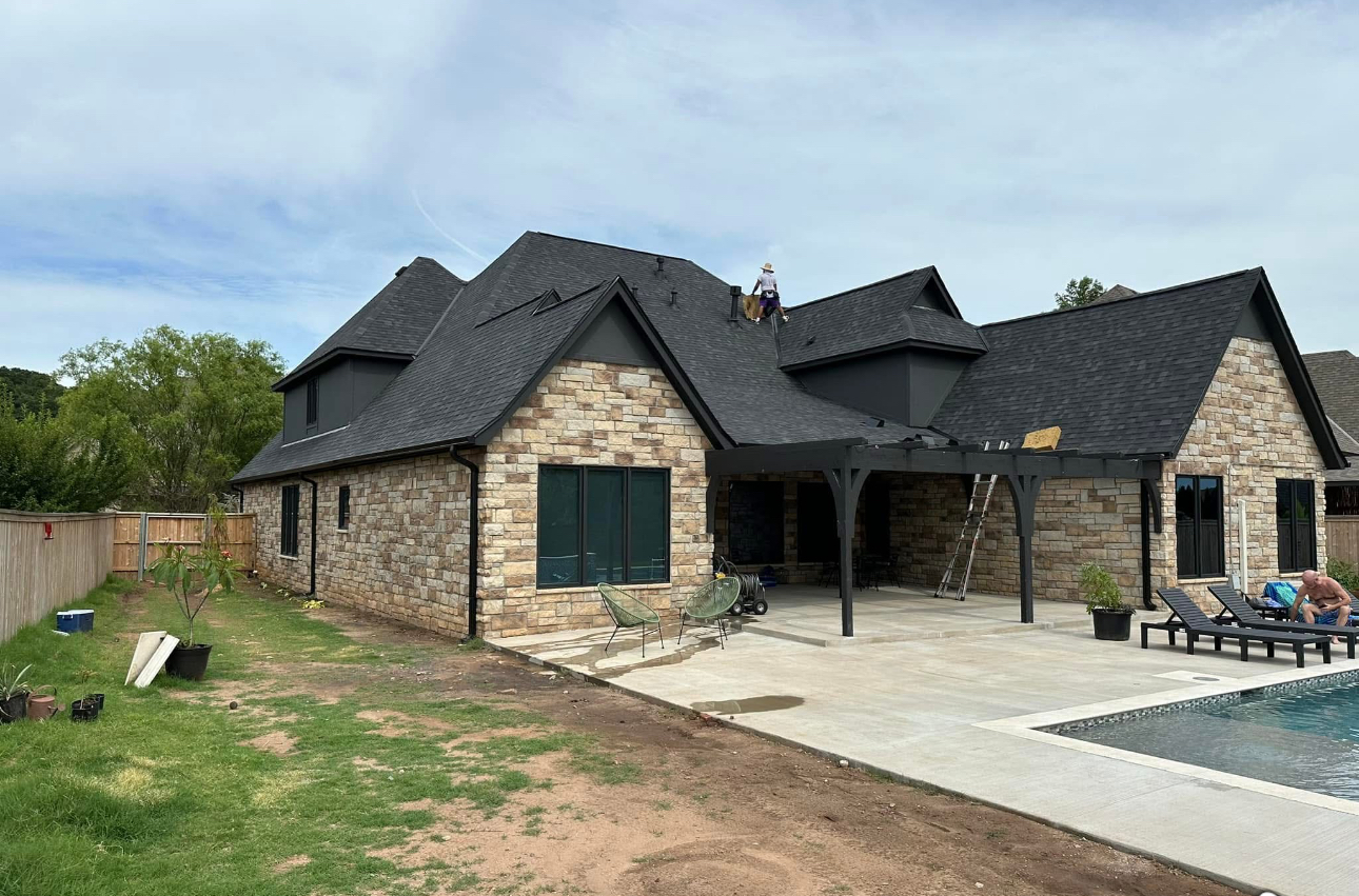 Completed dark shingle roof - rear view